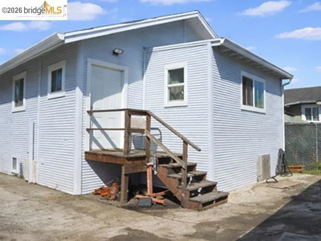 Light blue horizontal siding exterior featuring white trim windows