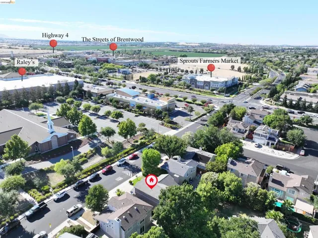 Aerial perspective showcasing a residential street with mature trees