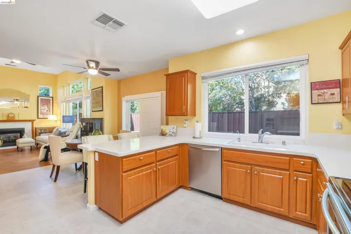 Kitchen featuring light wood cabinetry, light countertops, and stainless steel appliances