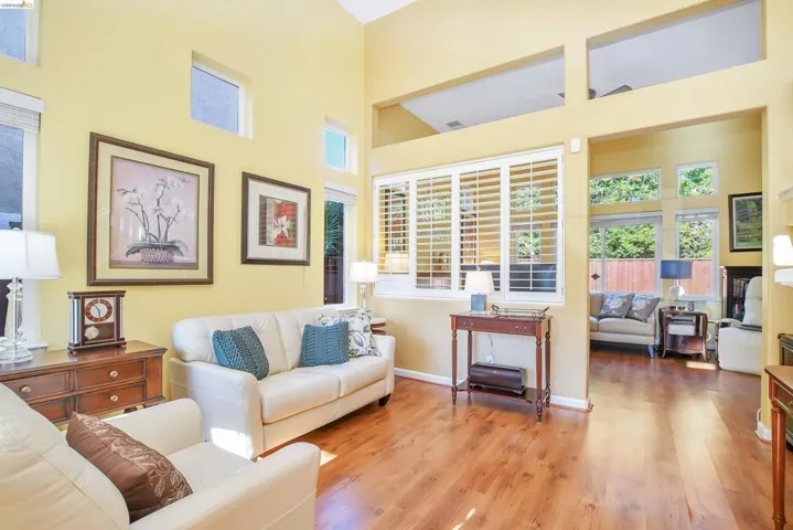 Vaulted ceilings framing transom windows and wood-finish flooring