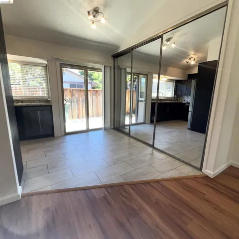 Tiled flooring extends from sliding glass doors opening to the exterior
