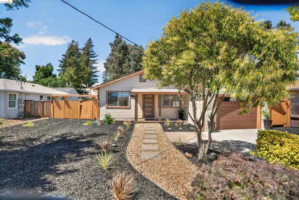 Contemporary ranch-style facade with a natural wood-finish garage door