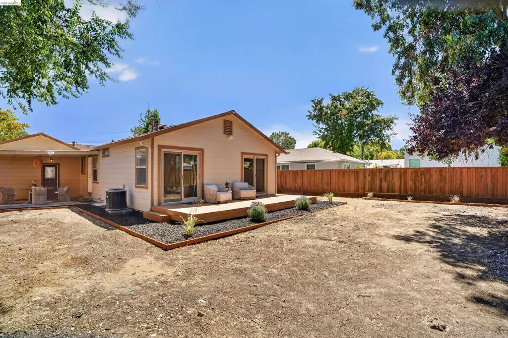 Expansive backyard space featuring a new wood privacy fence