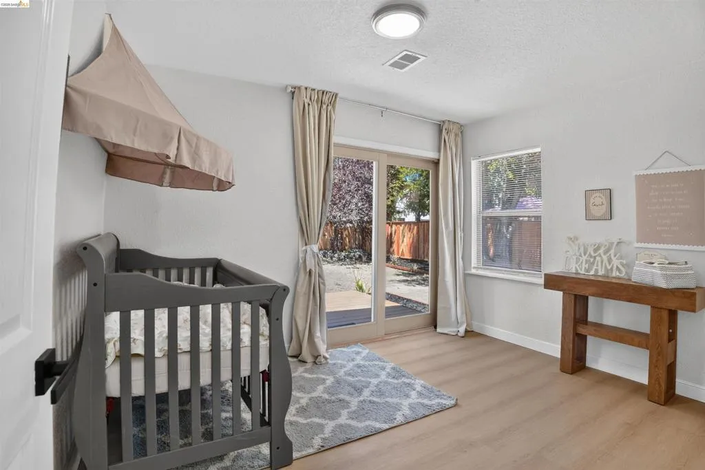 Light wood-finish flooring complements bright white walls
