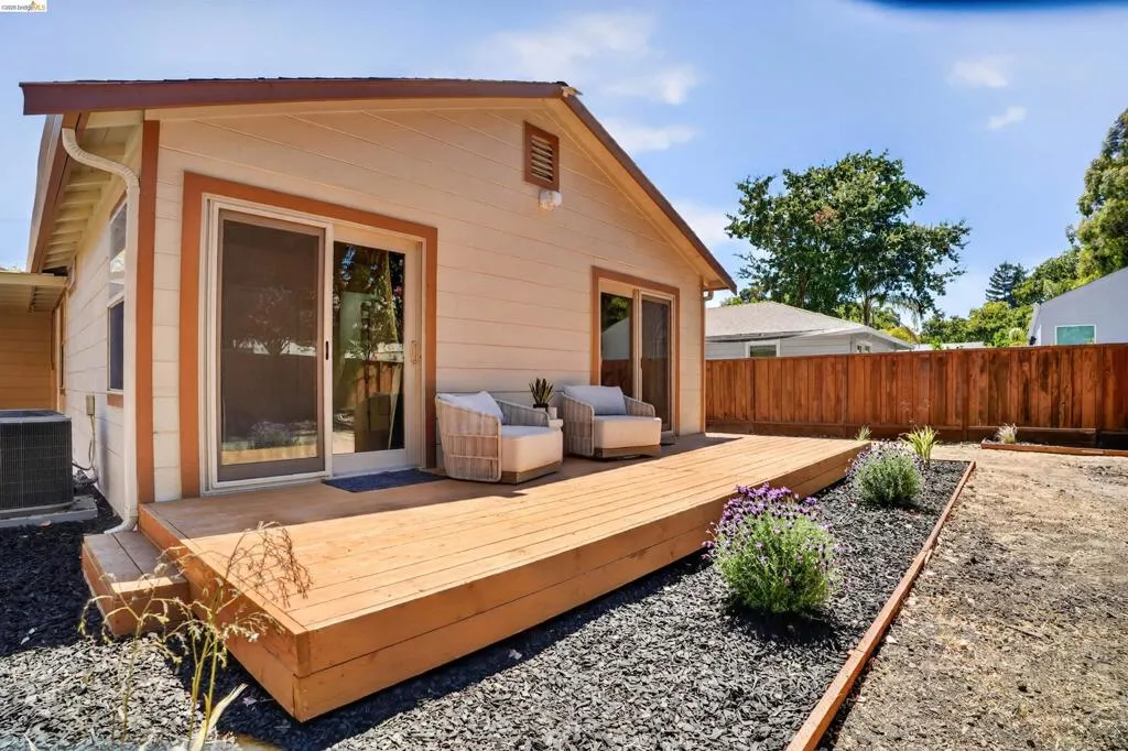 Expansive rear deck with sliding glass doors providing access to the interior