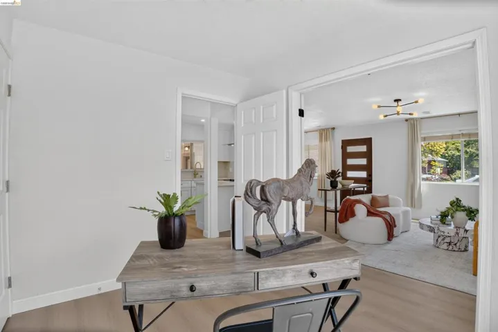 Open concept living area with light-toned wood-finish flooring