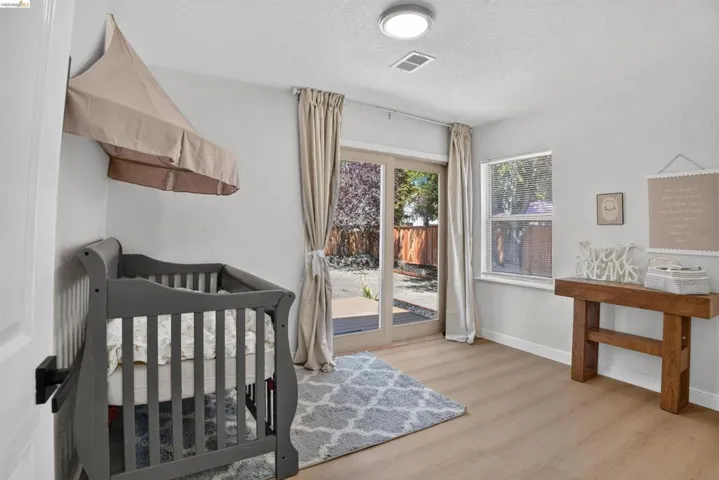 Light wood-finish flooring complements bright white walls