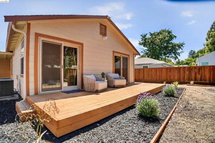 Expansive rear deck with sliding glass doors providing access to the interior
