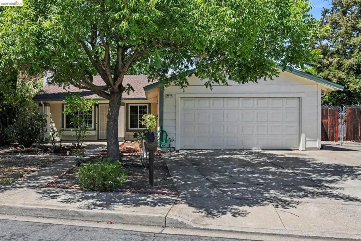 Single-story residence featuring a two-car garage and a paved driveway