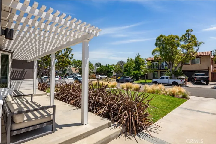 Inviting front porch featuring a cozy sitting area, perfect for relaxing and enjoying the outdoors.