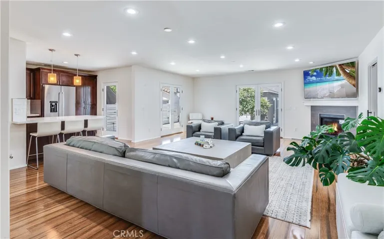 This stunning family room features an open-concept design that flows beautifully into the kitchen