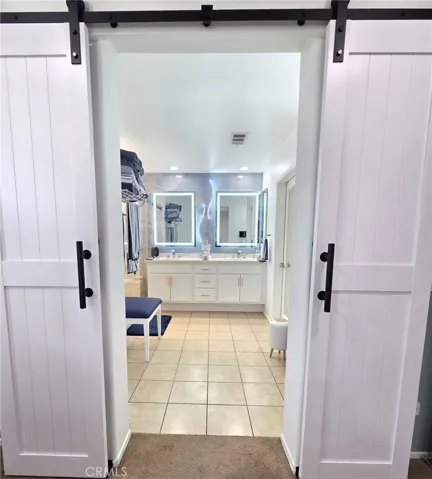 Farm door leading to the master bathroom
