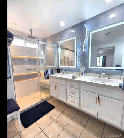 Master bathroom with lighted vanity mirrors.