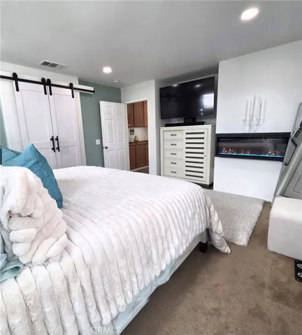Master bedroom #1 with a lighted fireplace
