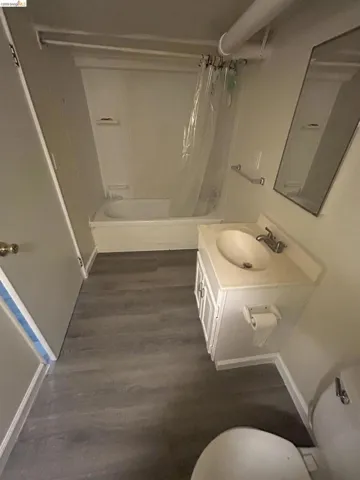 Bathroom featuring a white vanity with integrated sink, chrome faucet, and storage cabinetry