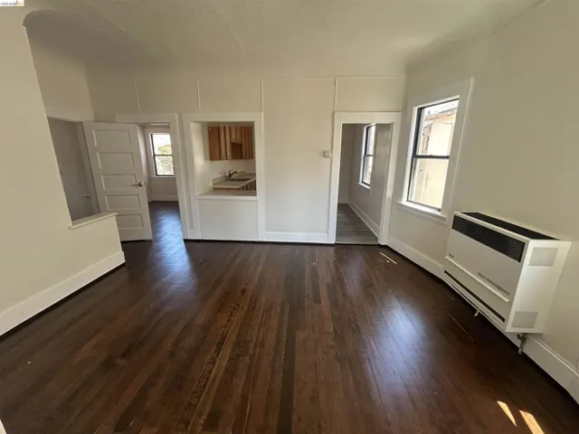 Rich wood-finish flooring extending throughout the space