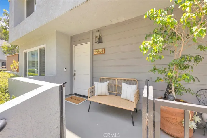Front porch over-looks plenty of green space.