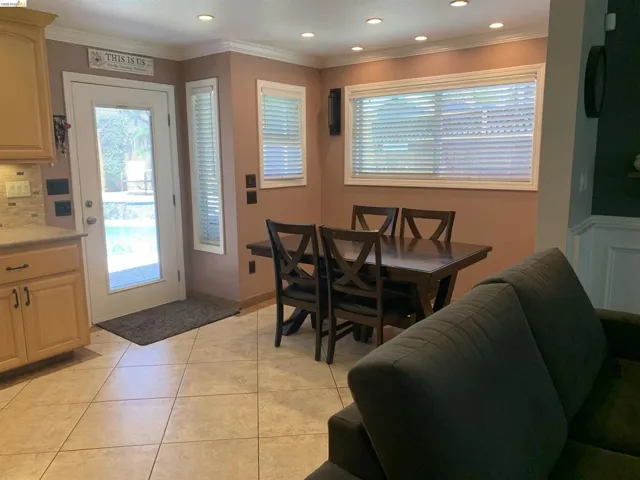 Dining area featuring tile flooring, recessed lighting, and a large window with horizontal blinds