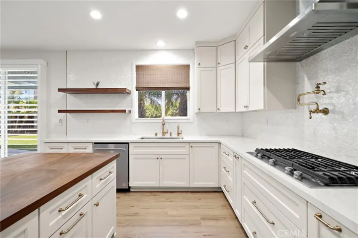 Kitchen with gas stove top and pot filler