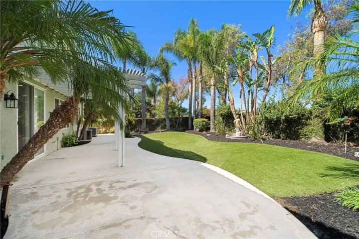 Entertainers backyard with lush landscape and turf