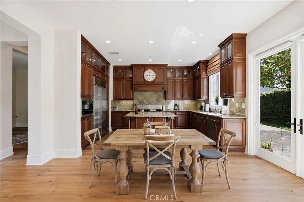 Kitchen and dining area Digitally altered and staged to show decorating potential with two extra chairs