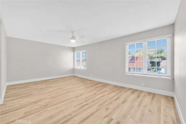 Spacious primary bedroom featuring natural light and generous floor space.