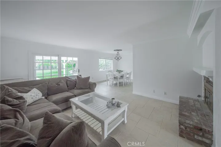 living room with fireplace and view into dining room