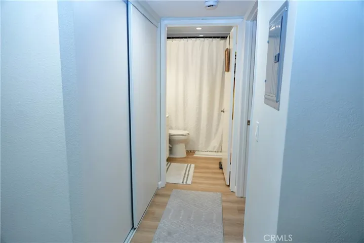 Hall with a closet leading to bathroom