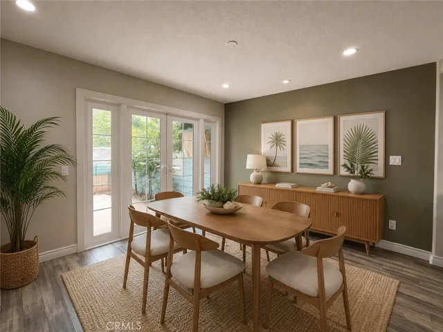 Dining room with French doors that lead to the back patio.  Digitally staged photo