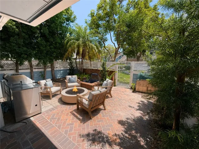 view of the patio/yard from the house. Digitally staged photo