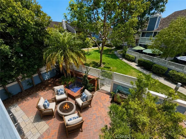 view from the balcony to the yard/patio. Digitally staged photo