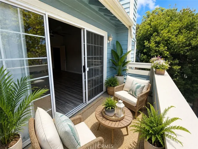 Balcony off the primary bedroom has great views!  Digitally staged photo