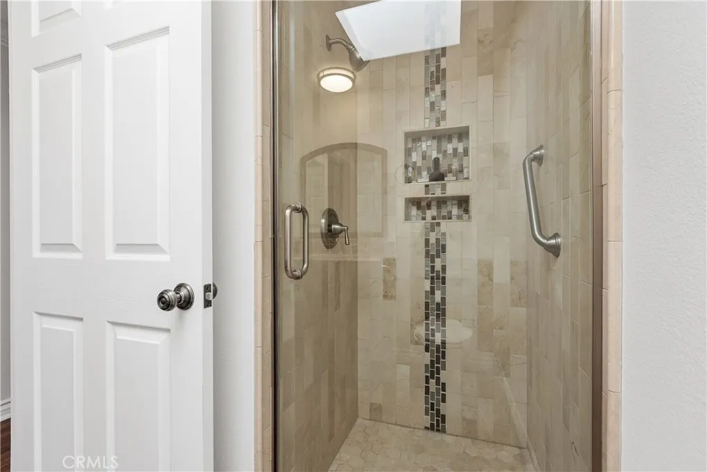 Tile finishes in the step-in shower. Tile finishes in the step-in shower.