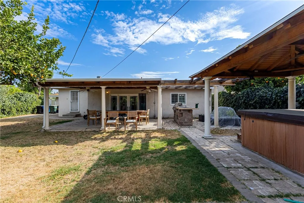 Covered patio with barbecue island and spa