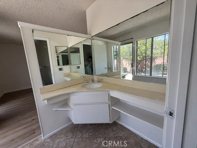 Primary bedroom with inside bathroom and vanity