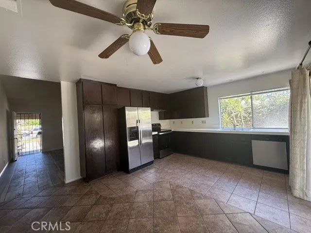 Open space kitchen with ceiling fan in dining area