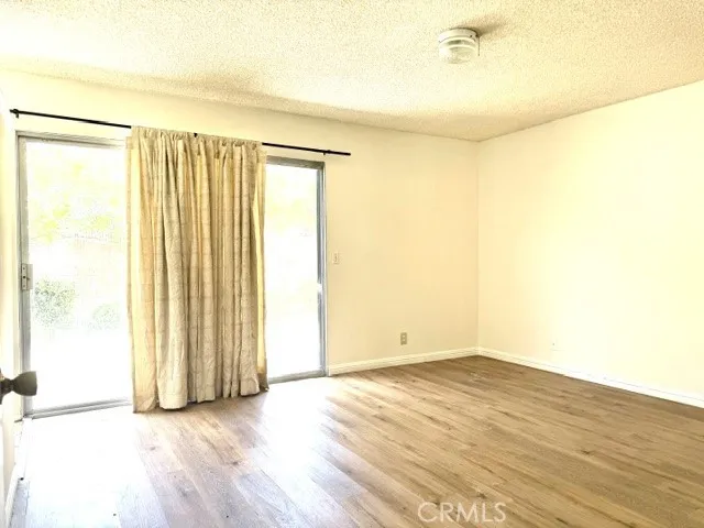 Primary bedroom with sliding door leads to backyard