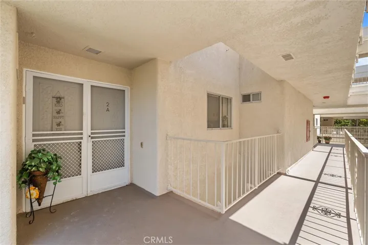 Upper-level walkway leading to the unit
