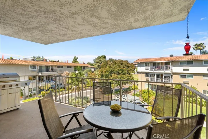 Covered balcony with outdoor seating and neighborhood views