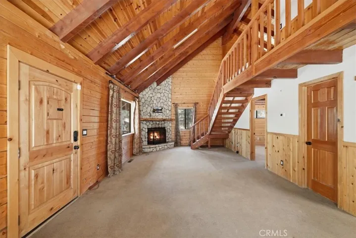 Rock fireplace and stairs leading to loft and Primary bedroom
