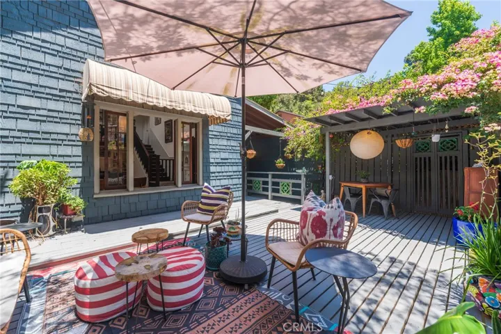 Private outdoor dining surrounded by mature landscaping and canyon tranquility, extending the home's living experience beyond its interior spaces.