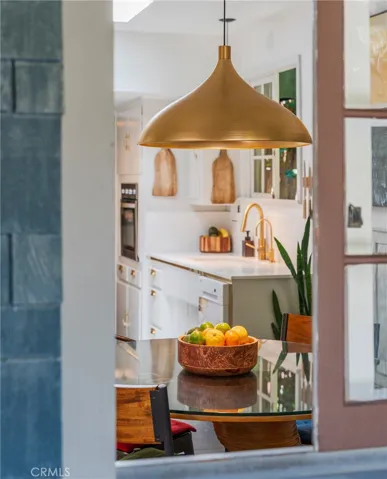 The kitchen serves as the heart of the home, connecting indoor gathering spaces with outdoor entertaining areas.