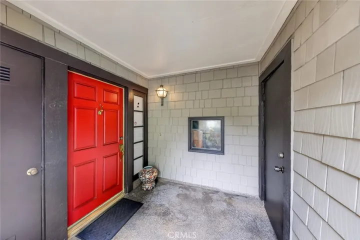 Inviting entry area featuring the front door and convenient access to the garage