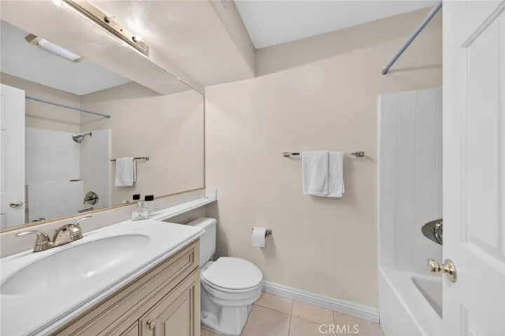 Second suite bathroom featuring tile flooring and a bathtub