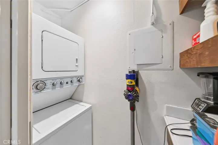Convenient laundry closet equipped with a stacked washer and dryer