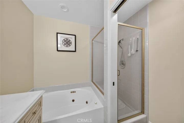 Primary bathroom featuring a relaxing bathtub and separate shower