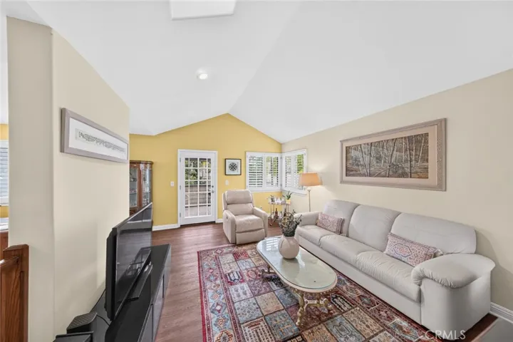 Spacious living room featuring soaring ceilings and a French door