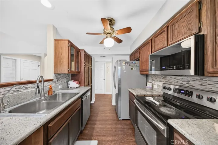 Well-appointed kitchen featuring granite countertops and a ceiling fan