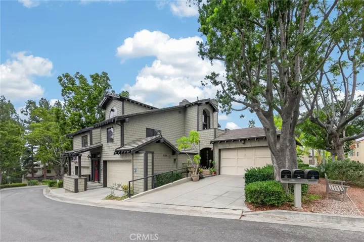 Welcoming front exterior featuring a long driveway and attractive curb appeal