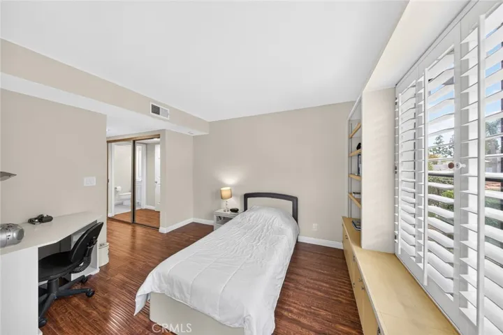 Second suite featuring built-in cabinetry and bookcases, offering versatile storage